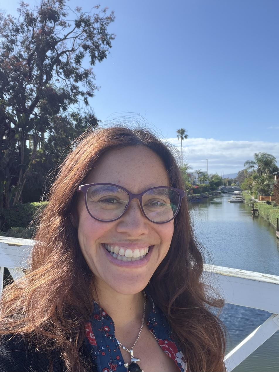 Kat Jong, MD smiling outdoors at the Venice Beach canals